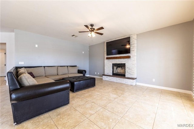 living room featuring light tile patterned floors, ceiling fan, a brick fireplace, and visible vents