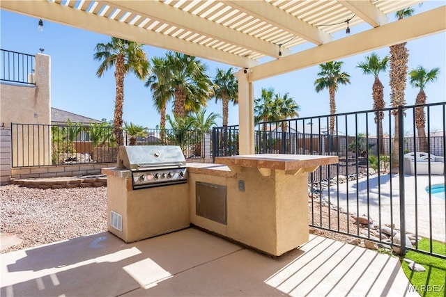 view of patio featuring exterior kitchen, fence, area for grilling, and a pergola