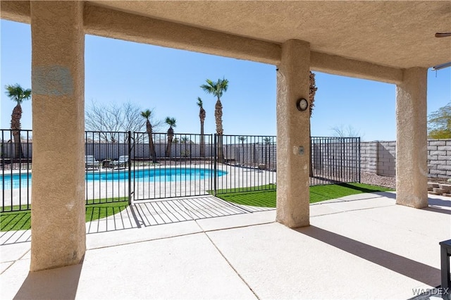 view of patio with fence and a community pool