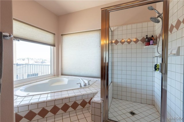 full bathroom featuring a stall shower and a bath