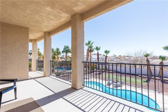 view of patio / terrace with a community pool and fence