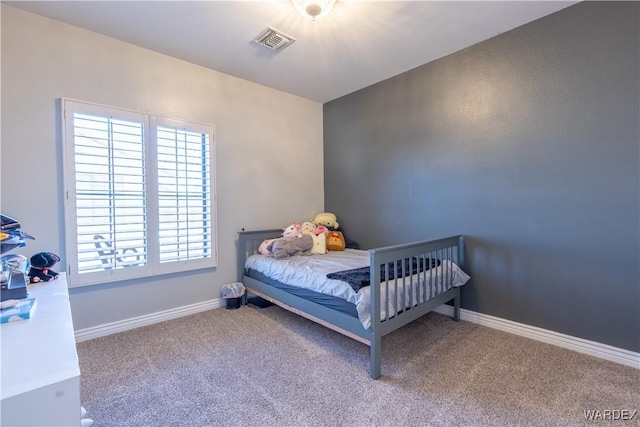 bedroom with carpet floors, baseboards, and visible vents