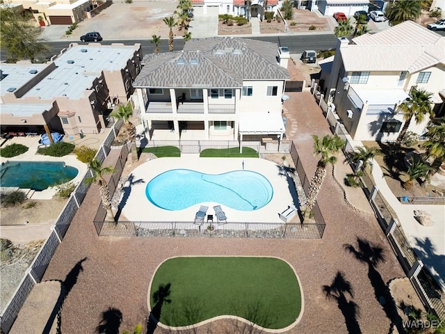 view of pool featuring a patio area, fence, and a residential view