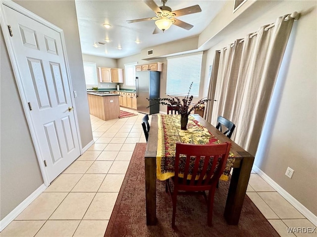 dining space featuring light tile patterned floors, visible vents, baseboards, and a ceiling fan