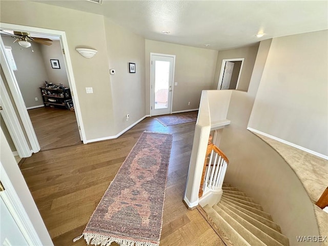 foyer entrance featuring baseboards and wood finished floors