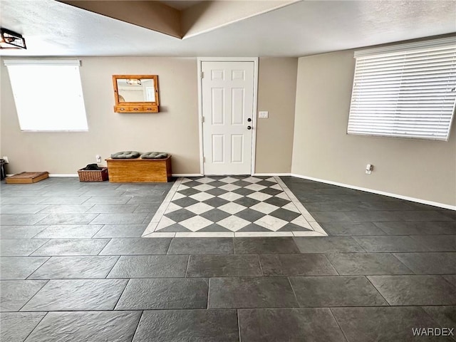 entryway featuring baseboards