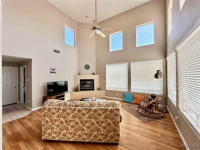 room details with a tiled fireplace, wood finished floors, and baseboards