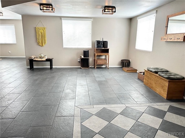 misc room featuring baseboards and tile patterned floors