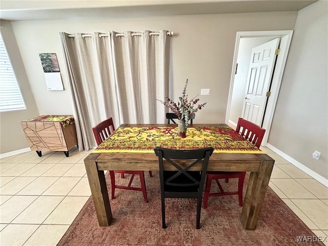 dining room with baseboards and light tile patterned floors