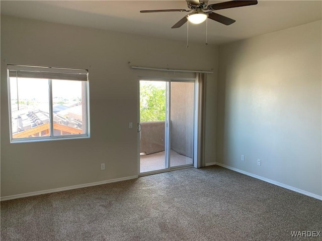 empty room featuring a ceiling fan, carpet flooring, and baseboards