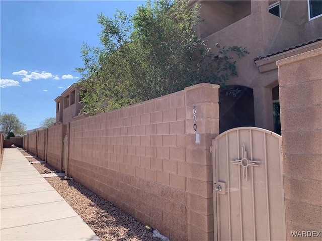 view of property exterior featuring a gate and fence