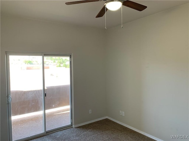 carpeted empty room featuring baseboards