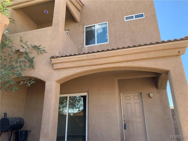 property entrance with stucco siding