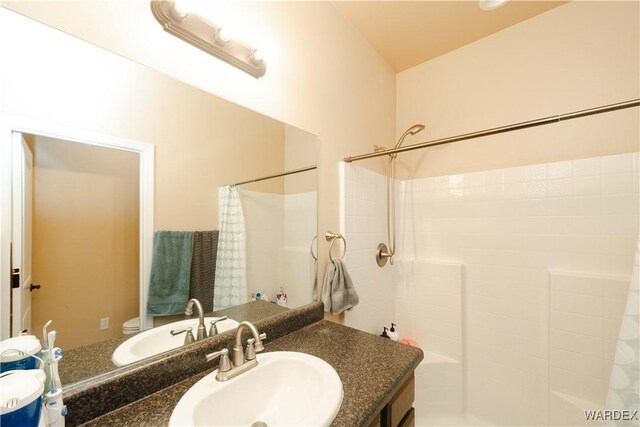 bathroom with toilet, a shower with curtain, and vanity