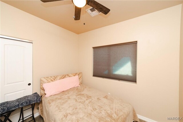 bedroom featuring a ceiling fan, visible vents, and baseboards