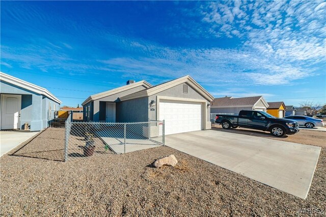 single story home featuring concrete driveway, an attached garage, fence, and stucco siding