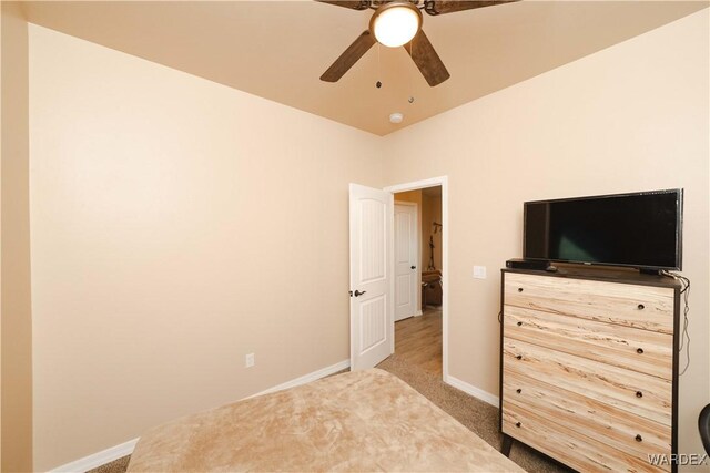 bedroom with a ceiling fan, carpet flooring, and baseboards