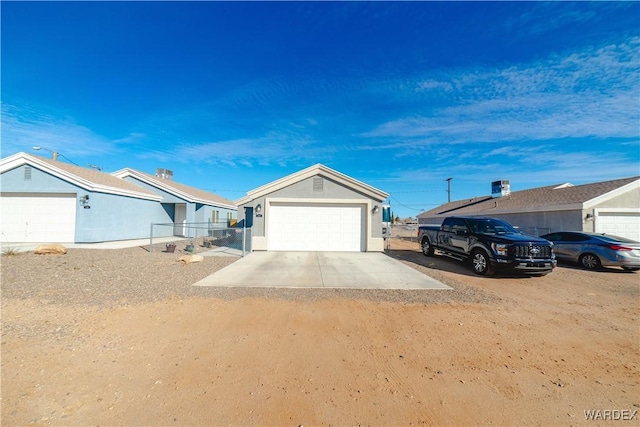 single story home featuring driveway, a garage, and stucco siding