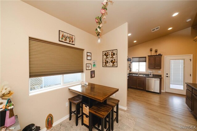 dining space with lofted ceiling, recessed lighting, visible vents, light wood-type flooring, and baseboards