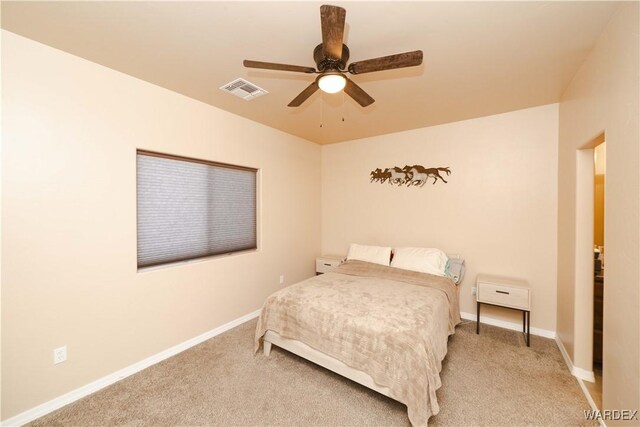 bedroom with light colored carpet, visible vents, and baseboards