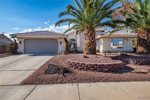 view of front of property featuring an attached garage, concrete driveway, and stucco siding