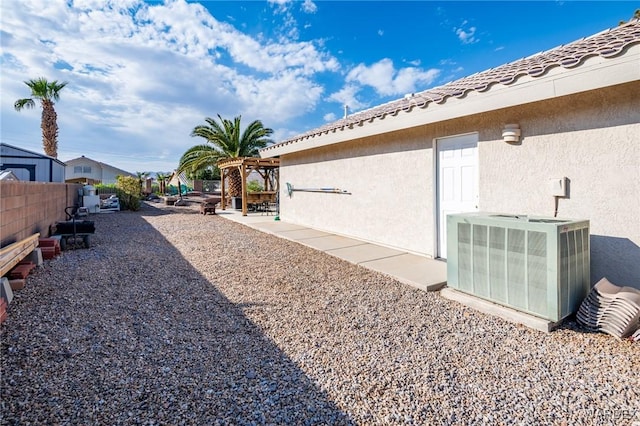 view of yard with a pergola, central AC, a patio, and fence