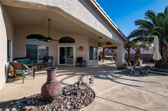 view of patio featuring ceiling fan and fence