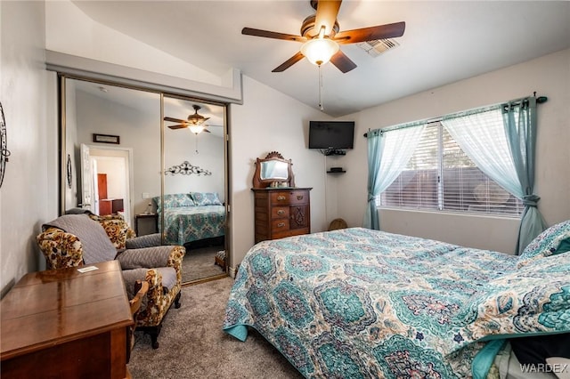 carpeted bedroom featuring lofted ceiling, a closet, visible vents, and ceiling fan