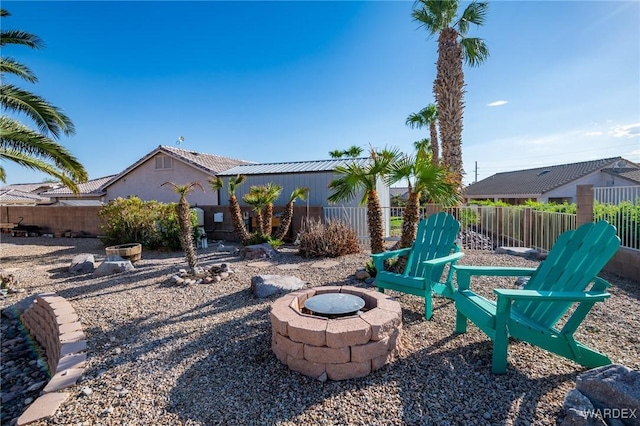 view of patio featuring an outdoor fire pit and fence