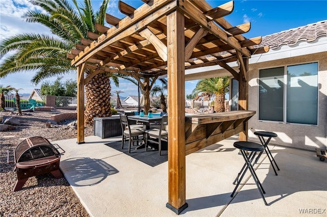 view of patio featuring a fire pit, fence, outdoor dining area, and a pergola