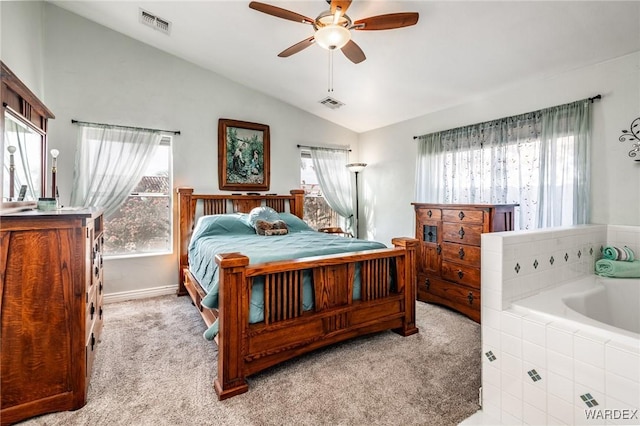 bedroom featuring light colored carpet, lofted ceiling, visible vents, and a ceiling fan