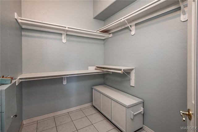 spacious closet with light tile patterned floors