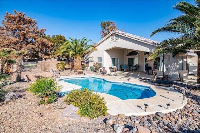 view of pool featuring ceiling fan, fence, a fenced in pool, and a patio