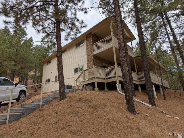 view of side of home with a balcony