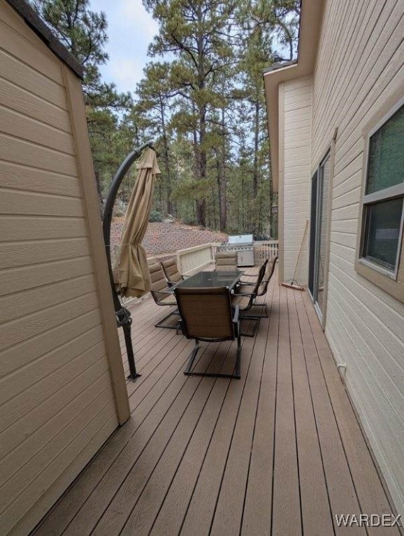 wooden terrace featuring outdoor dining space