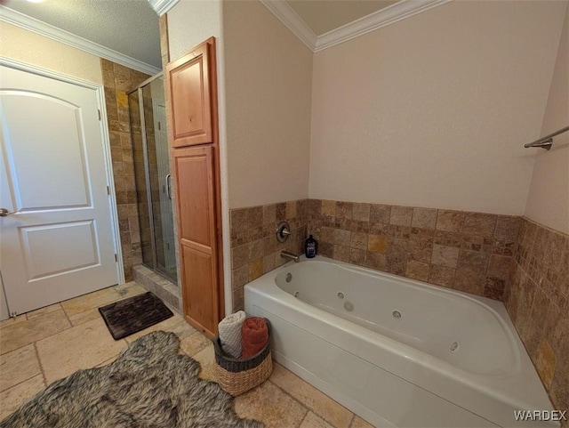 bathroom with ornamental molding, stone tile floors, a shower stall, and a whirlpool tub