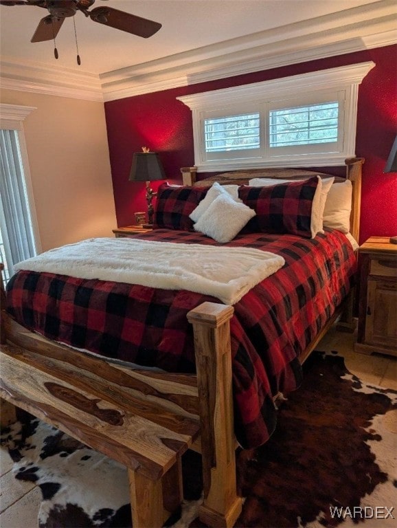 bedroom featuring multiple windows, ornamental molding, and a ceiling fan