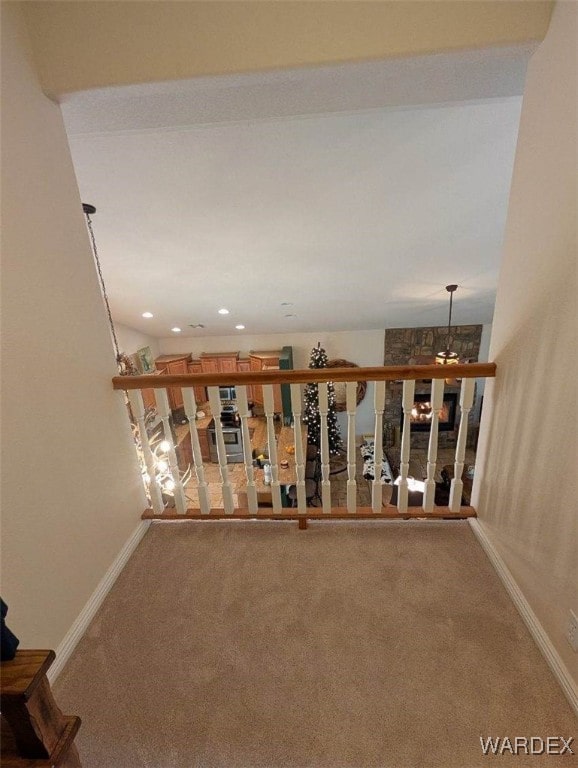 hallway featuring carpet floors and baseboards