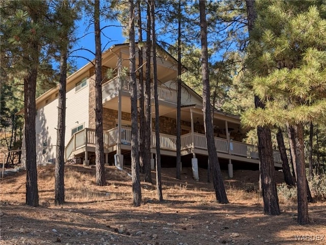 back of house featuring a balcony