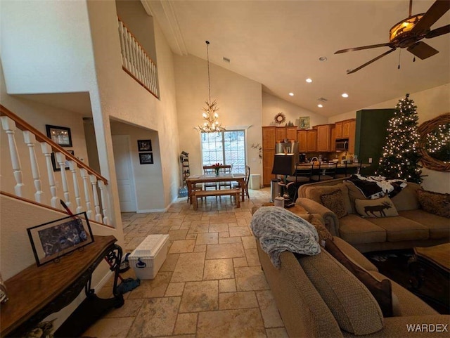 living area featuring baseboards, stairway, ceiling fan with notable chandelier, stone tile flooring, and recessed lighting