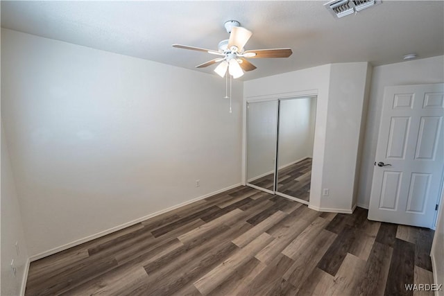 2970 E Devlin Ave, Kingman, AZ 86409 - unfurnished bedroom with baseboards, a closet, wood finished floors, and visible vents
