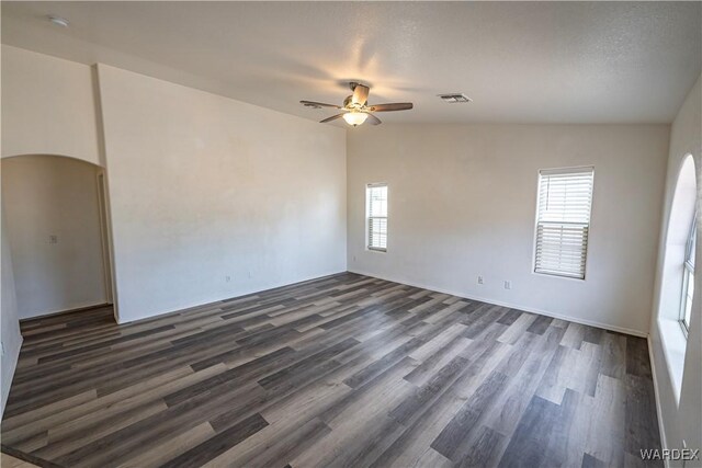 2970 E Devlin Ave, Kingman, AZ 86409 - spare room with visible vents, arched walkways, dark wood finished floors, and ceiling fan