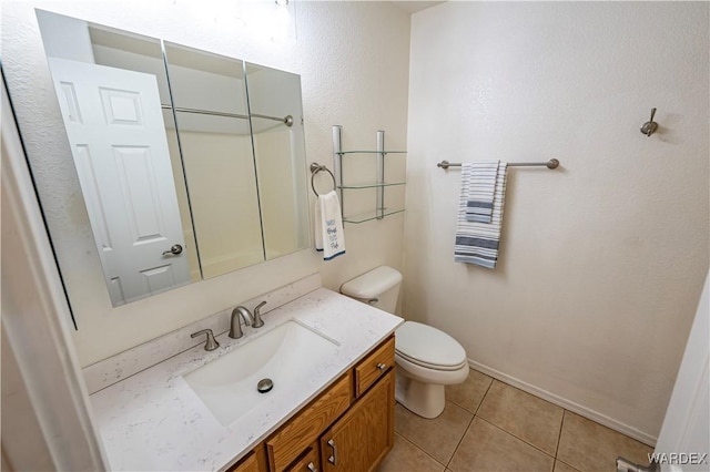 2970 E Devlin Ave, Kingman, AZ 86409 - bathroom with tile patterned flooring, baseboards, toilet, and vanity