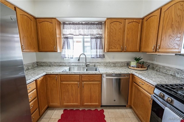 2970 E Devlin Ave, Kingman, AZ 86409 - kitchen featuring brown cabinetry, a sink, and appliances with stainless steel finishes