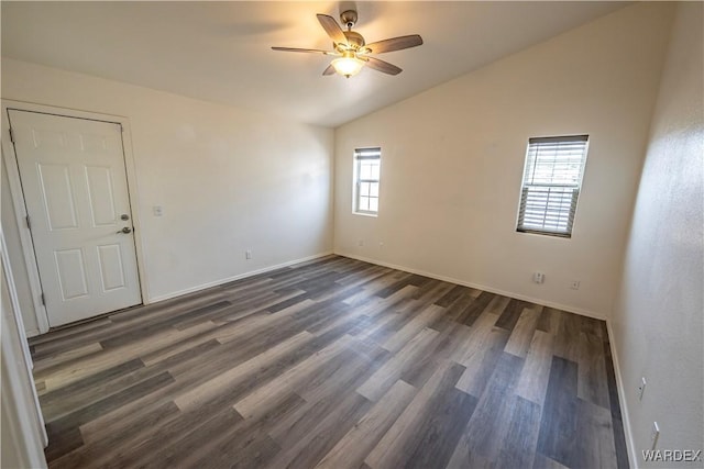 2970 E Devlin Ave, Kingman, AZ 86409 - empty room featuring dark wood-style flooring, ceiling fan, vaulted ceiling, and baseboards