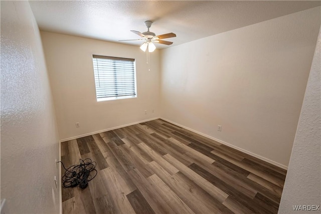 2970 E Devlin Ave, Kingman, AZ 86409 - spare room featuring dark wood-style flooring, a ceiling fan, and baseboards