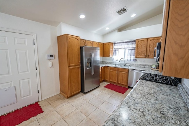 2970 E Devlin Ave, Kingman, AZ 86409 - kitchen featuring brown cabinets, a sink, stainless steel appliances, vaulted ceiling, and visible vents