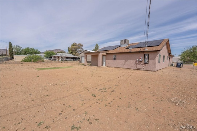 2970 E Devlin Ave, Kingman, AZ 86409 - rear view of house featuring a fenced backyard, stucco siding, and solar panels