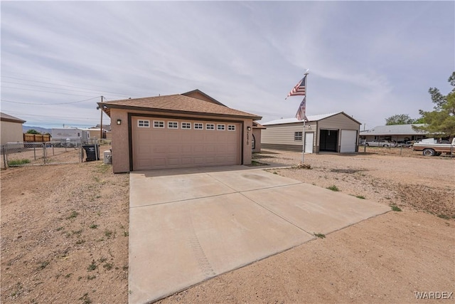 2970 E Devlin Ave, Kingman, AZ 86409 - exterior space featuring an outbuilding, a detached garage, fence, concrete driveway, and stucco siding