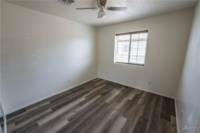 2970 E Devlin Ave, Kingman, AZ 86409 - empty room with ceiling fan, visible vents, baseboards, and dark wood-type flooring